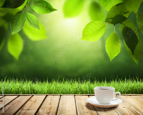 Photo: cup coffee and sunny trees background cup coffee and sunny trees background