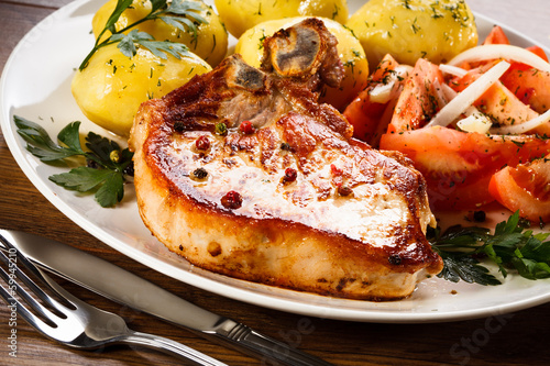 Photo: Grilled steak, boiled potatoes and vegetable salad Grilled steak, boiled potatoes and vegetable salad