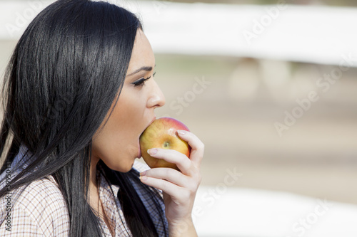Photo: Young woman with an apple Young woman with an apple