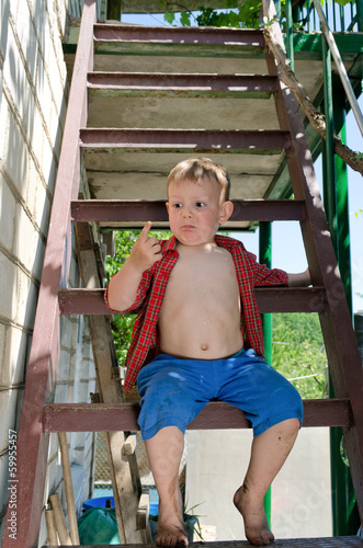 Photo: Little boy looking at his finger in astonishment Little boy looking at his finger in astonishment