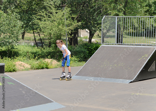 Photo: Teenage girl skating in a skate park Teenage girl skating in a skate park