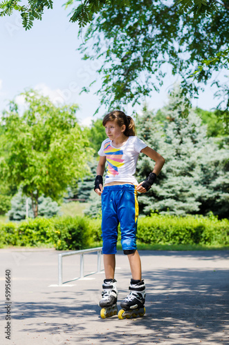 Photo: Teenage girl putting on her skating gear Teenage girl putting on her skating gear