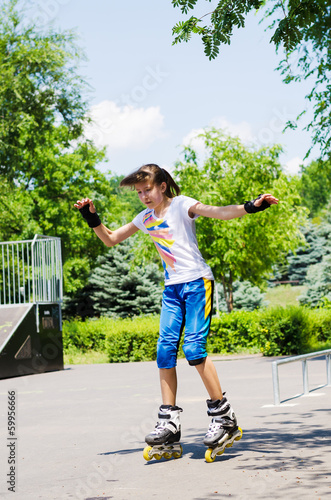 Photo: Pretty teenage girl skating in a skate park Pretty teenage girl skating in a skate park