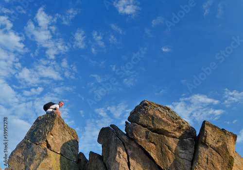 Photo: Backpacker on a distant rocky mountain peak Backpacker on a distant rocky mountain peak