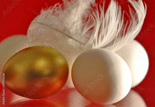 Photo: goldenes und weiße Eier mit Federn goldenes und weiße Eier mit Federn
