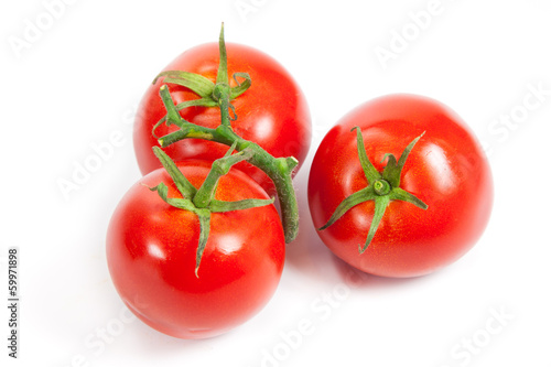 Photo: three fresh tomatoes with green leaves isolated on white backgro three fresh tomatoes with green leaves isolated on white backgro