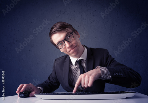 Photo: Hacker working with keyboard on blue background Hacker working with keyboard on blue background