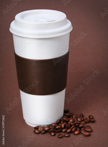 Photo: Coffee cup with Coffee Beans on brown background. Takeaway Coffee cup with Coffee Beans on brown background. Takeaway