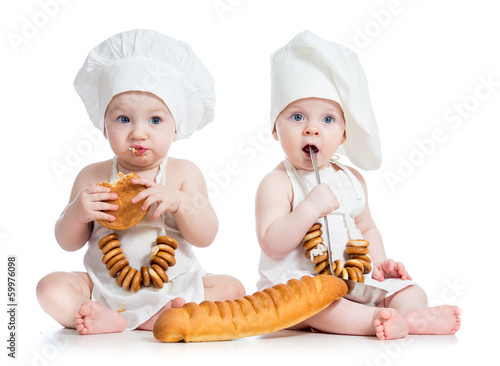 Photo: Little bakers kids boy and girl isolated Little bakers kids boy and girl isolated