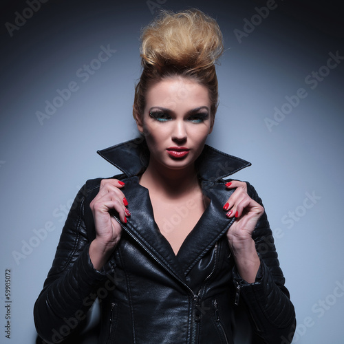 Photo: sexy blonde woman pulling her leather jacket's collar sexy blonde woman pulling her leather jacket's collar
