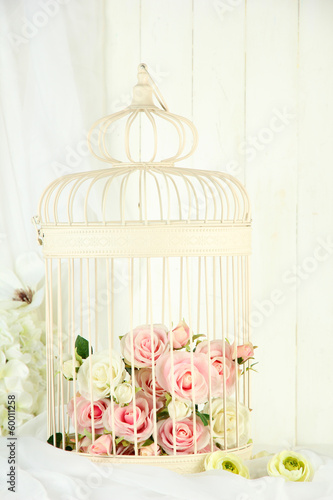 Photo: Beautiful decorative cage with beautiful flowers Beautiful decorative cage with beautiful flowers