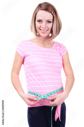 Photo: Young pregnant woman measuring her belly isolated on white Young pregnant woman measuring her belly isolated on white