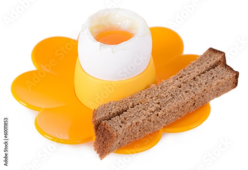 Photo: Boiled egg in egg cup isolated on white Boiled egg in egg cup isolated on white