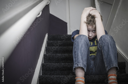 Photo: scared boy on stairs, child abuse scared boy on stairs, child abuse