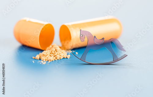 Photo: vitamins in capsules and toy horse vitamins in capsules and toy horse