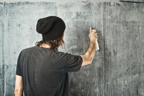 Photo: Graffiti artist spraying the wall Graffiti artist spraying the wall