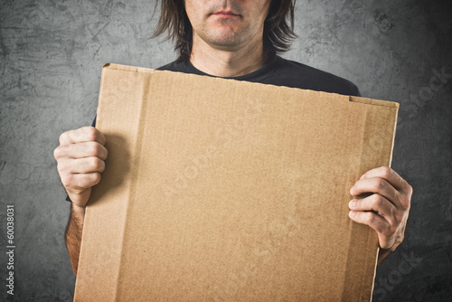 Photo: Man holding cardboard paper Man holding cardboard paper