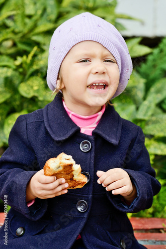 Photo: funny toddler girl eating outdoors funny toddler girl eating outdoors