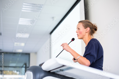 Photo: Pretty, young business woman giving a presentation Pretty, young business woman giving a presentation