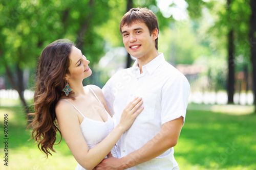 Photo: Young love Couple smiling under blue sky Young love Couple smiling under blue sky