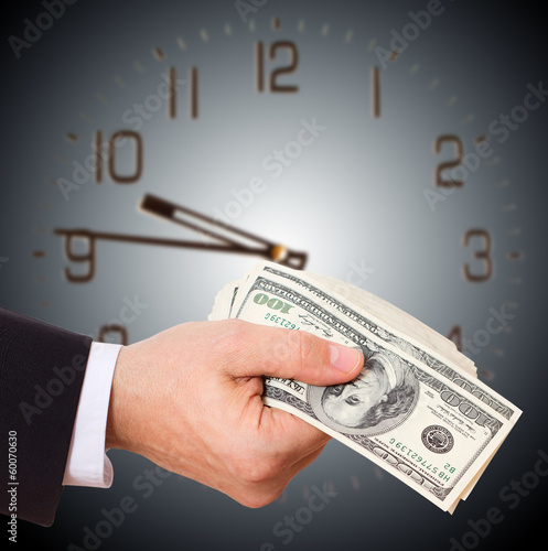 Photo: Businessman holding cash dollars in hands Businessman holding cash dollars in hands