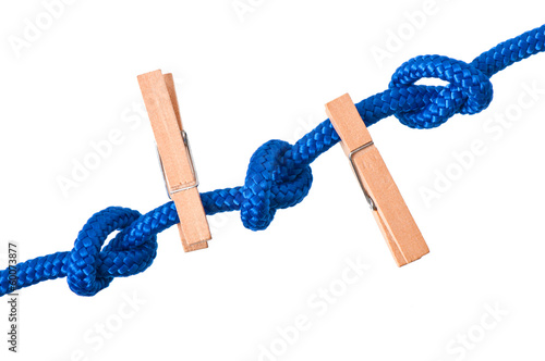 Photo: clothespins on a blue rope on white background clothespins on a blue rope on white background