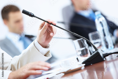Photo: Hands of businessman holding microphone Hands of businessman holding microphone