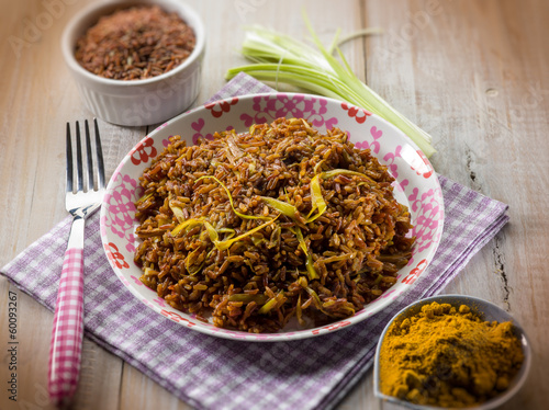 Photo: red rice with curry and leek, selective focus red rice with curry and leek, selective focus