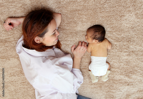 Photo: young mother with her newborn baby young mother with her newborn baby