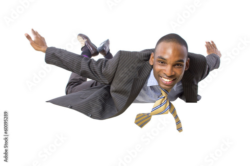Photo: young african american businessman flying or skydiving young african american businessman flying or skydiving