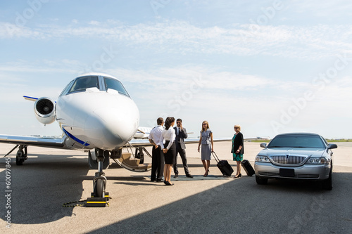 Photo: Business People With Pilot And Airhostess At Terminal Business People With Pilot And Airhostess At Terminal