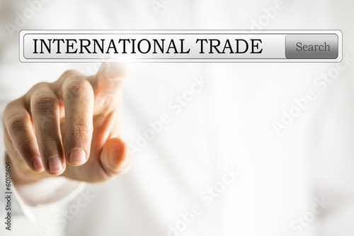 Photo: Hand clicking to search for international trade Hand clicking to search for international trade