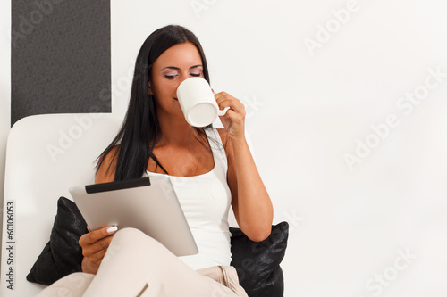 Photo: Woman with a digital tablet at home Woman with a digital tablet at home