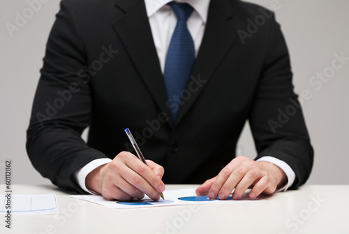 Photo: close up of businessman with papers close up of businessman with papers