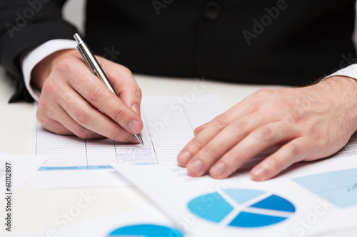 Photo: close up of businessman with papers close up of businessman with papers