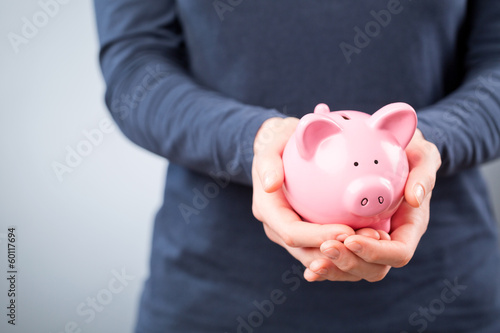 Photo: Care for Savings - Woman with a Piggy Bank Care for Savings - Woman with a Piggy Bank