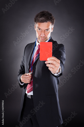 Photo: Businessman Showing Red Card Businessman Showing Red Card