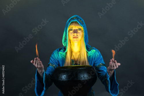Photo: Witch with fire in hands creates a spell Witch with fire in hands creates a spell