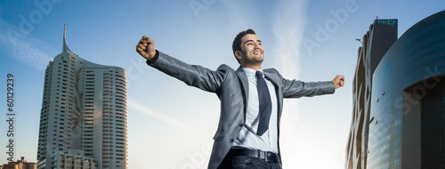 Photo: Successful businessman with his arms wide open Successful businessman with his arms wide open