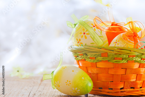 Photo: easter basket and eggs on wooden board easter basket and eggs on wooden board