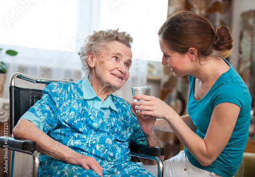Photo: senior woman with her home caregiver senior woman with her home caregiver