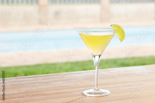 Photo: Classic daiquiri cocktail by a pool outdoors Classic daiquiri cocktail by a pool outdoors