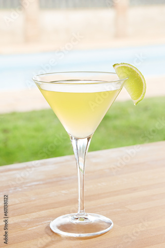 Photo: Classic daiquiri cocktail by a pool outdoors Classic daiquiri cocktail by a pool outdoors