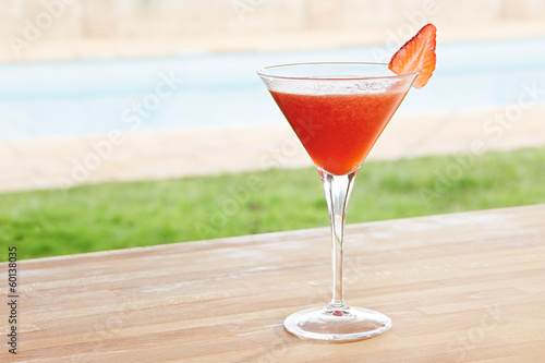 Photo: Strawberry daiquiri cocktail by a pool outdoors Strawberry daiquiri cocktail by a pool outdoors