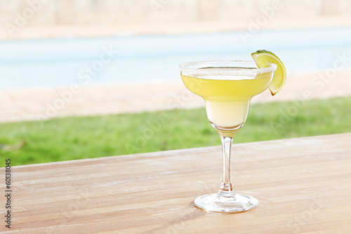 Photo: Margarita cocktail by a pool outdoors Margarita cocktail by a pool outdoors