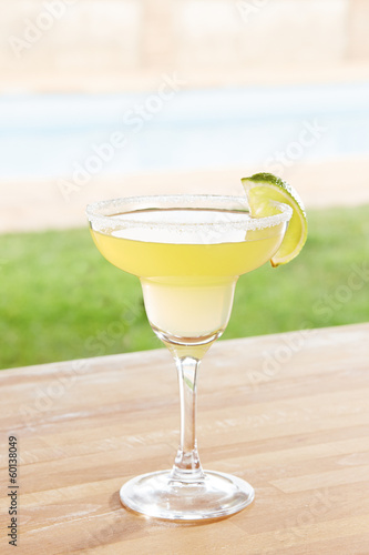 Photo: Margarita cocktail by a pool outdoors Margarita cocktail by a pool outdoors