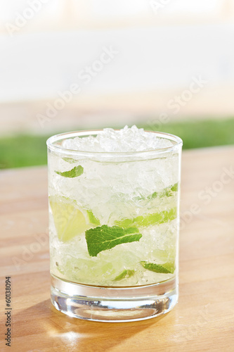 Photo: Classic mojito cocktail by a pool outdoors Classic mojito cocktail by a pool outdoors