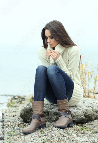 Photo: Portrait of young serious woman near river Portrait of young serious woman near river