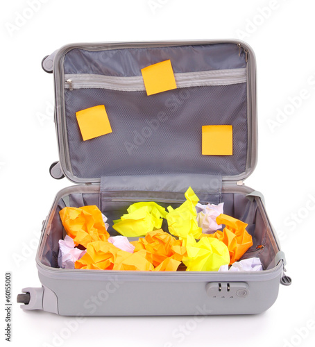 Photo: Open suitcase with paper stickers isolated on white Open suitcase with paper stickers isolated on white