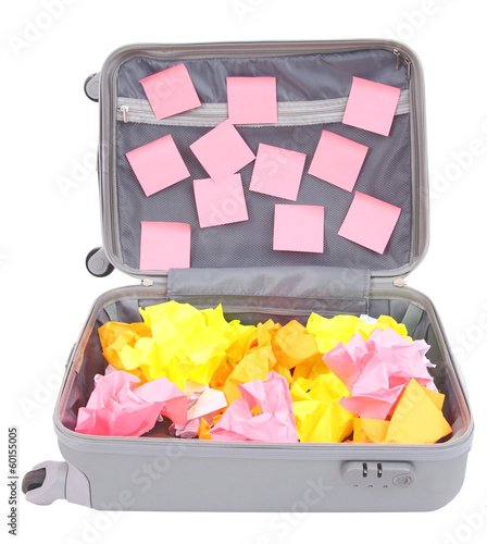 Photo: Open suitcase with paper stickers isolated on white Open suitcase with paper stickers isolated on white